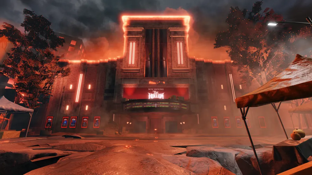 Official The Hollow hub exterior at night with a lit theater marquee, red fog, and ticket booths.