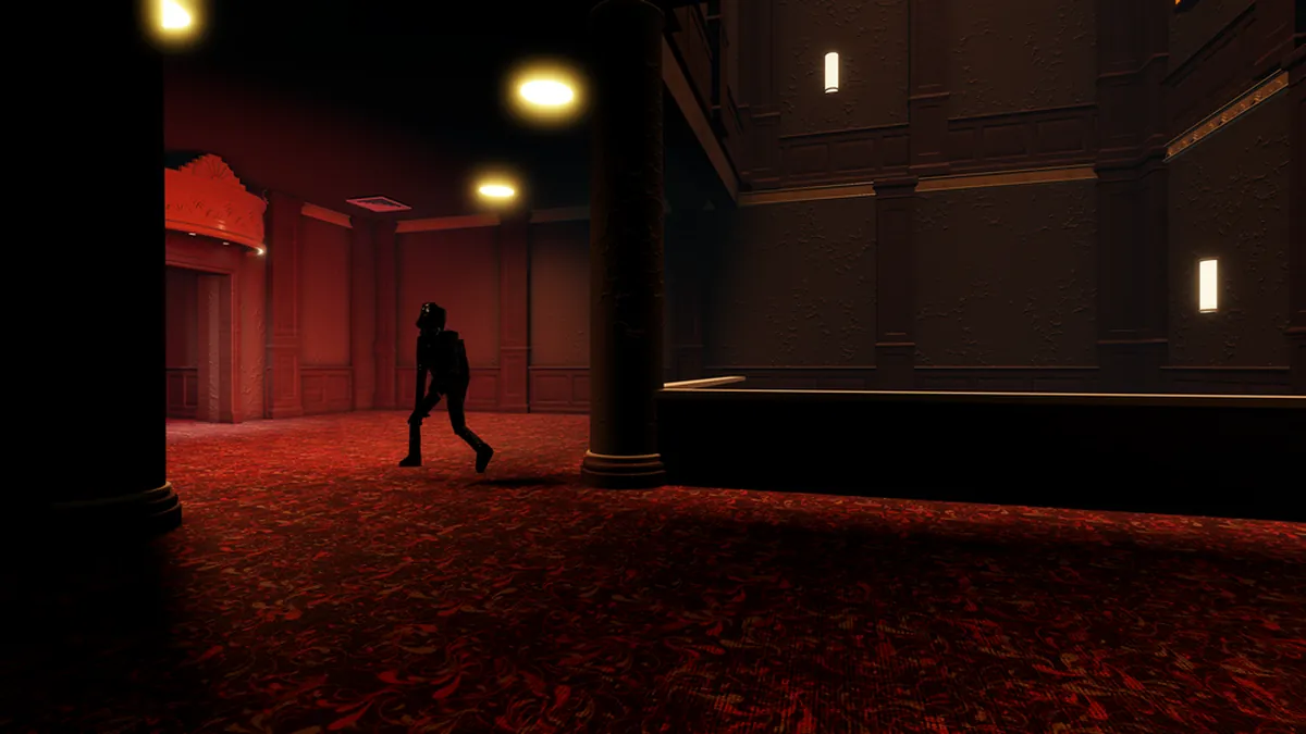 Official interior view of The Hollow theater with a dark monster silhouette on a red carpet.